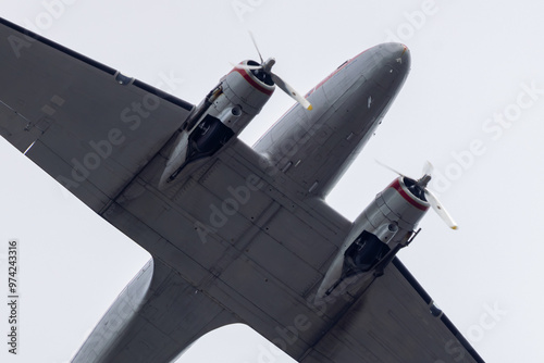 Close-up of an old vintage DC 3 airplane flying above the city of Haarlem, Netherlands