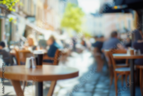 Blurred background of People sitting at tables in outdoor cafe, on bustling street. Relaxed atmosphere, featuring individuals enjoying coffee and casual conversation in lively city environment.