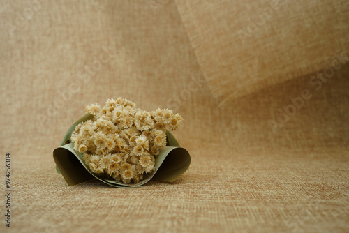 A bucket of dried edelweiss on rustic jute fabric