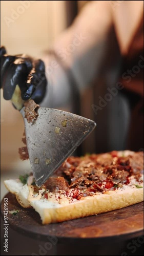 Street food, fast food. The process of making shawarma. The process of preparing street food. Vegetables and meat in a freshly baked loaf. The chef's work in slow motion. High quality 4k footage.