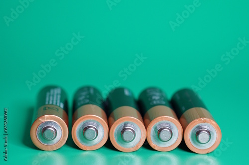 Finger batteries on a green background.