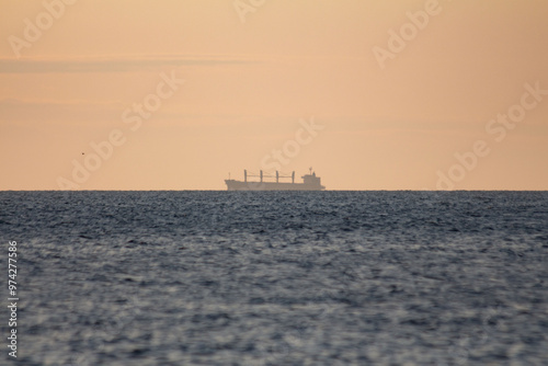 A shadow of the ship in the morning sea