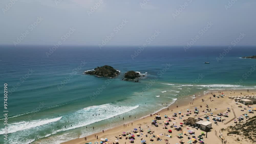 Aerial dolly orbit in Chia, Sardinia, Italy around Su Giudeu Island with view of Su Giudeu Beach. Beautiful seascape and crowded beach. 4K Drone Video. Aerial Shot. Aerial dolly orbit in Chia, Sardinia, Italy around Su Giudeu Island with view of Su Giudeu Beach. Beautiful seascape and crowded beach. 4K Drone Video. Aerial Shot.