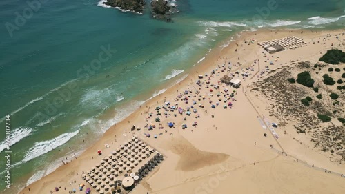 Aerial dolly in Chia, Sardinia, Italy with view of Su Giudeu Beach. Beautiful seascape and crowded beach. 4K Drone Video. Aerial Shot.