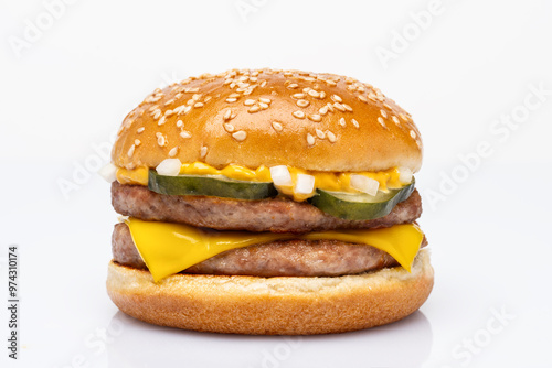 Double burger with pork patty, cheddar cheese, pickled cucumber, onion and burger sauce on white background