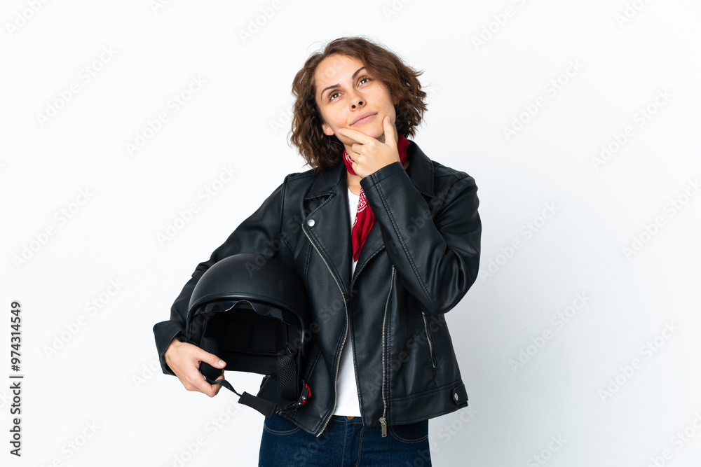 English woman holding a motorcycle helmet isolated on white background having doubts English woman holding a motorcycle helmet isolated on white background having doubts