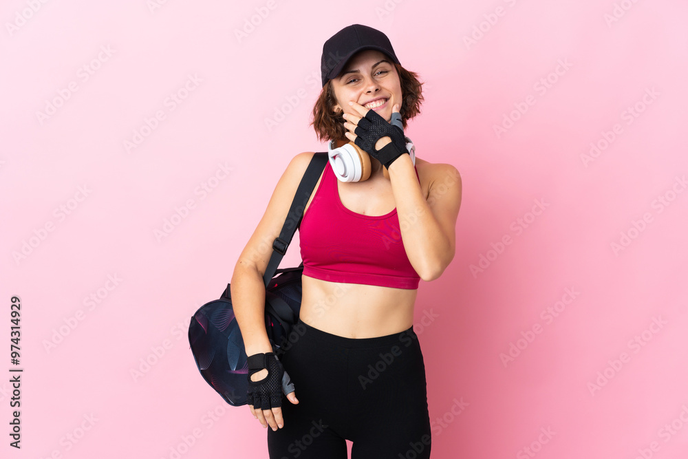 Obraz premium Young sport woman with sport bag over isolated background happy and smiling
