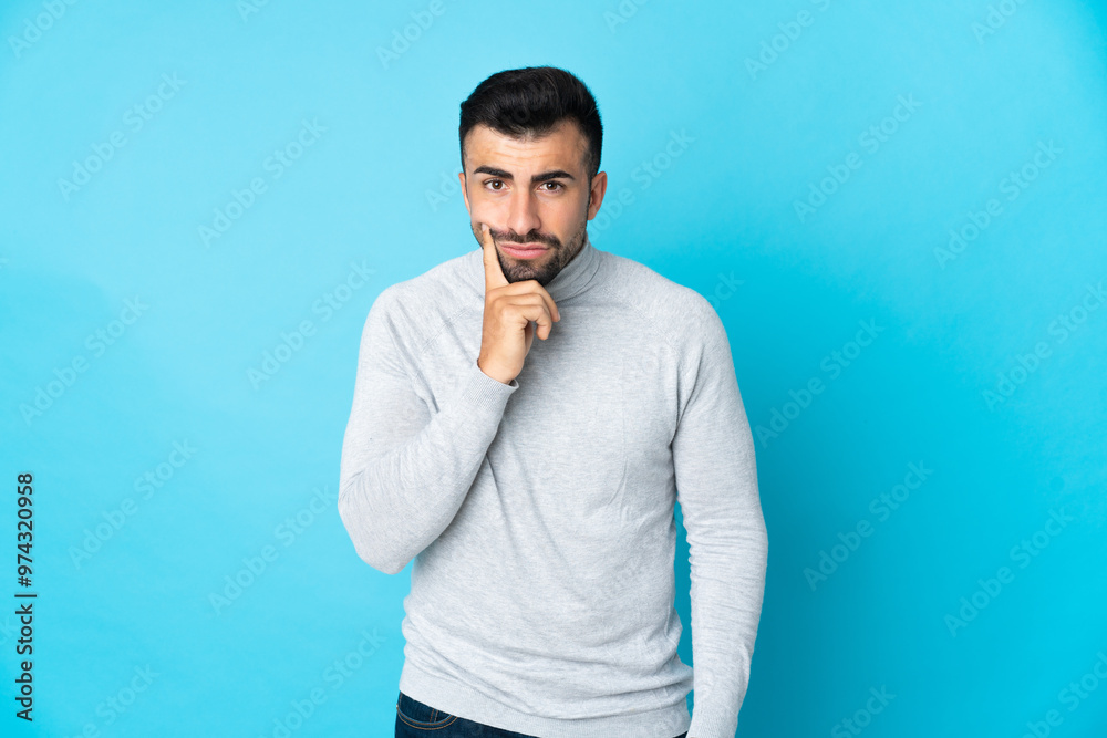 Caucasian man over isolated blue background and thinking Caucasian man over isolated blue background and thinking