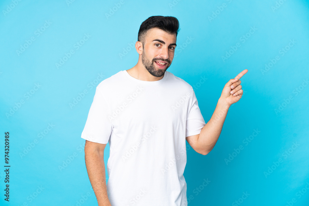 Caucasian man over isolated blue background pointing finger to the side Caucasian man over isolated blue background pointing finger to the side