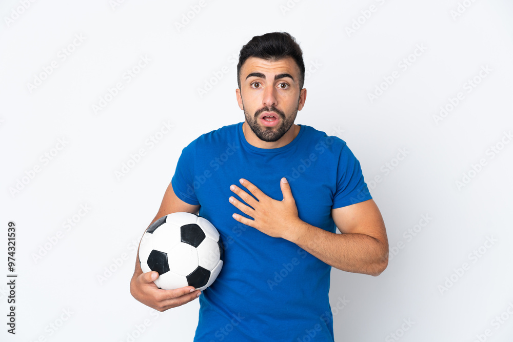 Handsome young football player man over isolated wall surprised and shocked while looking right Handsome young football player man over isolated wall surprised and shocked while looking right