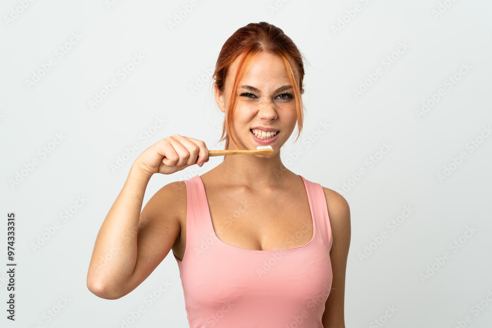 Teenager Russian girl isolated on white background with a toothbrush Teenager Russian girl isolated on white background with a toothbrush