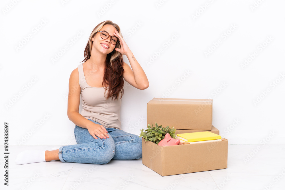 Young Russian girl sitting on the floor isolated on white background has realized something and intending the solution Young Russian girl sitting on the floor isolated on white background has realized something and intending the solution