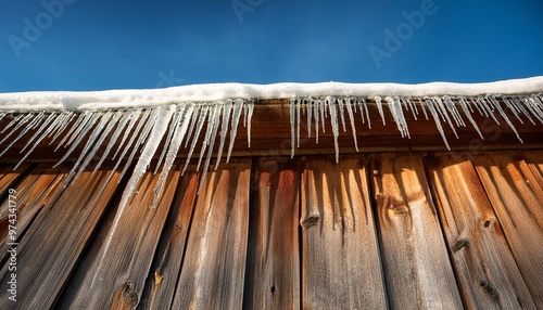 Icicles hanging from a wooden barn roof