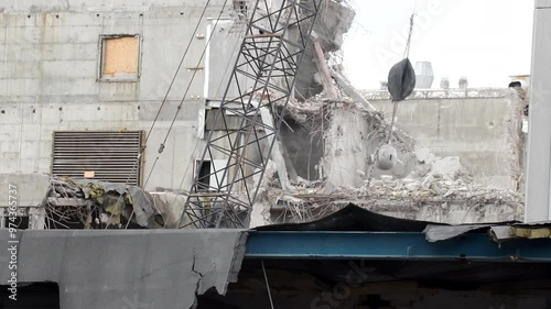 Wrecking ball being used for demolition of concrete building