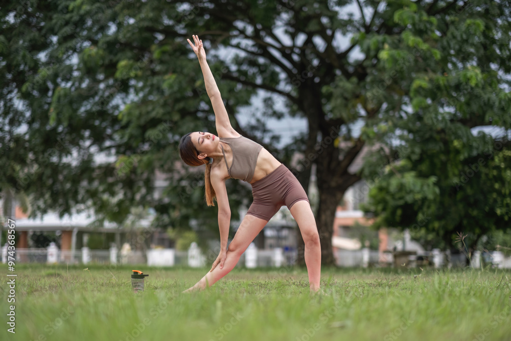Young Woman Practicing Yoga Outdoors in a Park on a Sunny Day, Embracing Nature and Wellness Young Woman Practicing Yoga Outdoors in a Park on a Sunny Day, Embracing Nature and Wellness