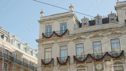 A neoclassical architecture building in Lisbon Portugal decorated for Christmas. Upcoming holiday celebrations in the capital city of Portugal building are decorated with beautiful ornaments