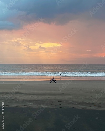 Motorbike on beach at sunset