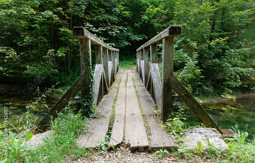 Small wooden bridge over a creek in the middle of the forest