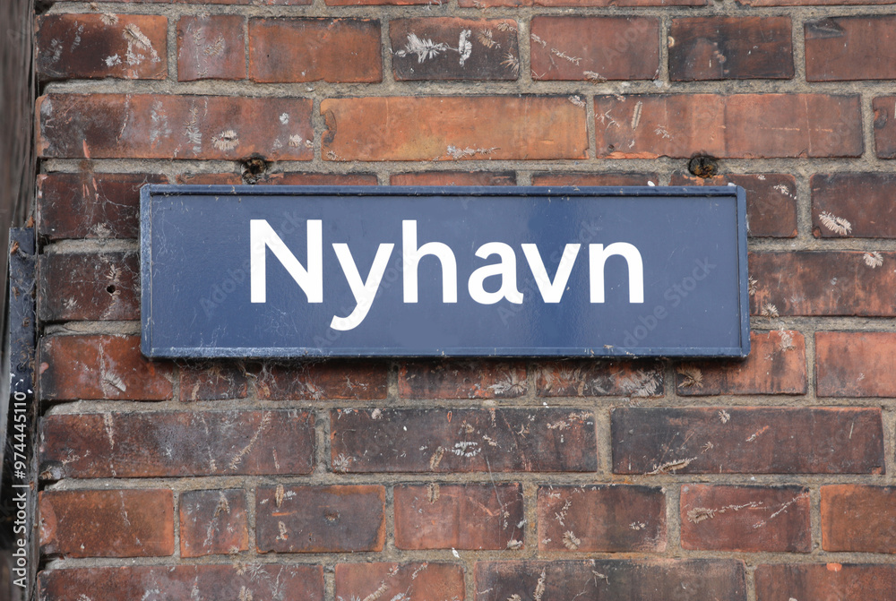 Obraz premium Text in Danish language NYHAVN which means new harbour is the district of Copenhagen in Denmark with the canal and coloured houses