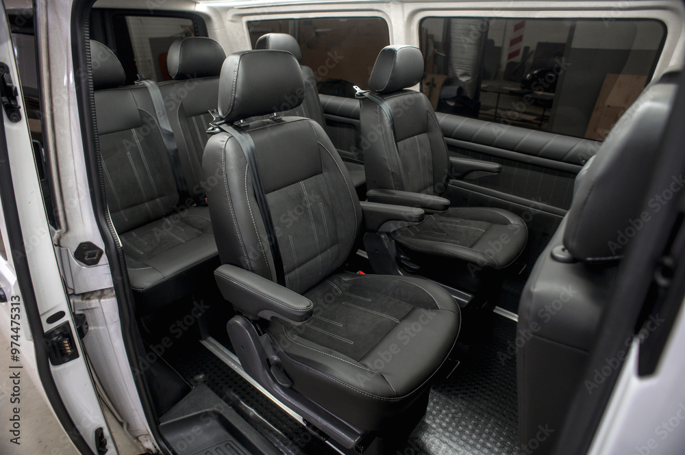 Obraz premium Comfortable interior of a passenger bus with soft seats. The design is made to order. Private covering of cars. Various elements of the bus interior.