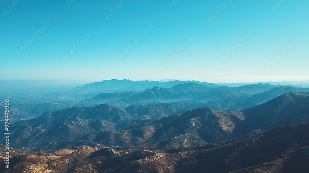 Misty mountain landscape under clear blue sky Misty mountain landscape under clear blue sky