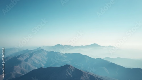 Misty blue mountains under clear sky