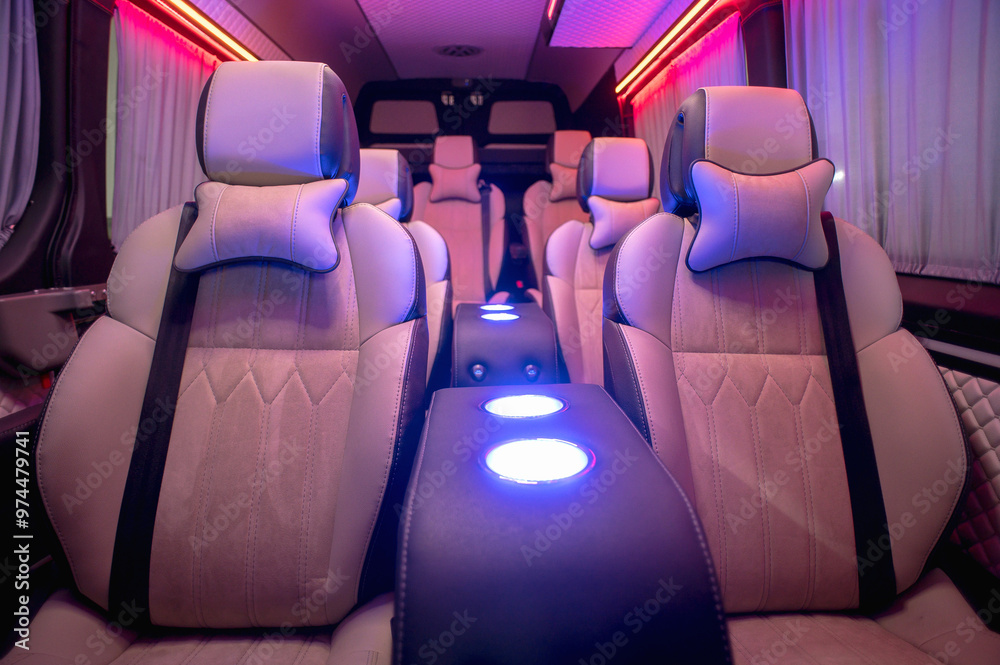 Obraz premium Comfortable interior of a passenger bus with soft seats. The design is made to order. Private covering of cars. Various elements of the bus interior.