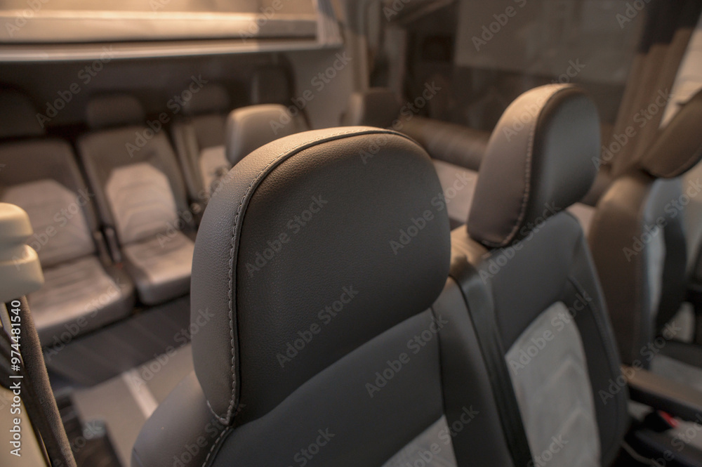 Obraz premium Comfortable interior of a passenger bus with soft seats. The design is made to order. Private covering of cars. Various elements of the bus interior.