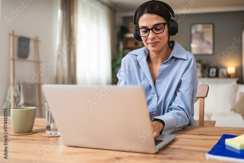 Freelance businesswoman entrepreneur working on laptop from home office. Business female work as finance and economy adviser for clients and companies that hire her. Modern solutions working at home.