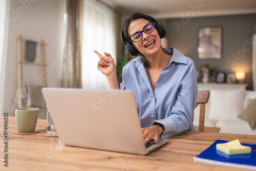 Freelance businesswoman entrepreneur working on laptop from home office. Business female work as finance and economy adviser for clients and companies that hire her. Modern solutions working at home.