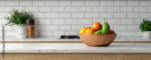 A vibrant bowl of fresh fruits sits on a modern kitchen countertop, highlighting a clean and stylish culinary space.
