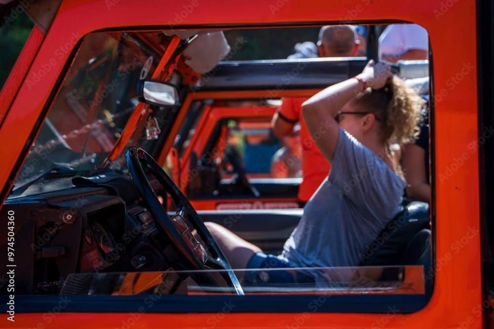 People Enjoying Off-Road Adventure in Bright Orange Vehicle, off the grid venture