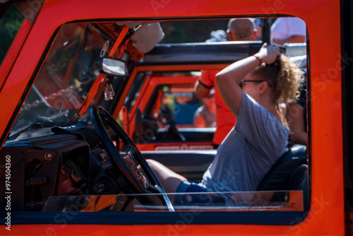 Obraz na płótnie People Enjoying Off-Road Adventure in Bright Orange Vehicle, off the grid venture w salonie