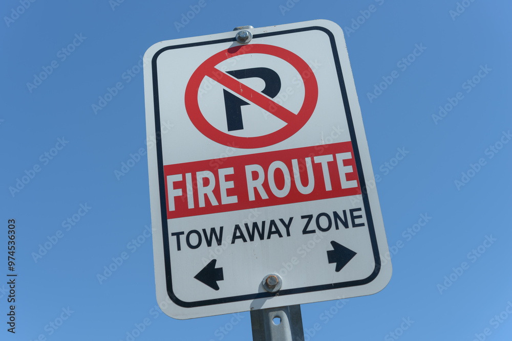 no parking, fire route, tow away zone sign on a blue sky no parking, fire route, tow away zone sign on a blue sky