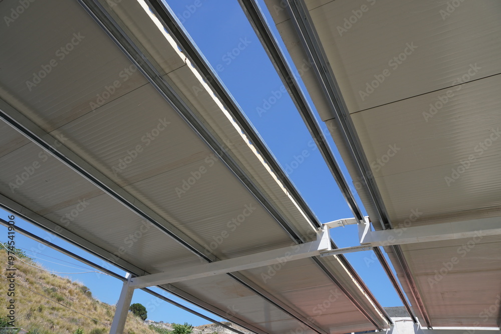 Obraz premium Industrial roofing made of sandwich panels. Composition of the building frame. Steel frame of the building. Modern construction of industrial buildings. Hangar construction 