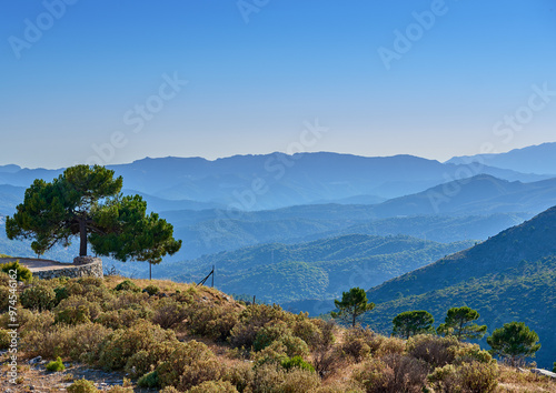 Landscape, trees and mountain outdoor in nature for travel, vacation or holiday in Spain. Hill, sky and plants in countryside with ancient architecture, cobblestone wall or mockup space in Andalusia