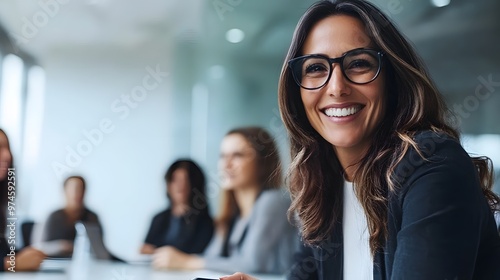 Smiling Businesswoman in Glasses and Black Blazer at a Meeting