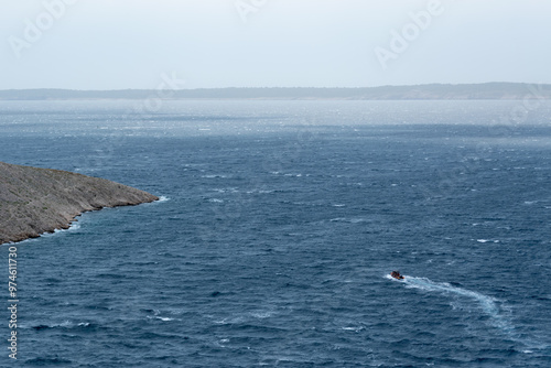 Fototapeta Naklejka Na Ścianę i Meble -  Boat sails on wavy sea on wind