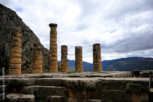 Ruins of the ancient Temple of Apollo in Delphi with its mighty round columns in Greece, overlooking the valley of Phocis on a sunny day in summer photo