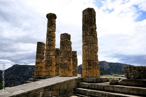 Ruins of the ancient Temple of Apollo in Delphi with its mighty round columns in Greece, overlooking the valley of Phocis on a sunny day in summer