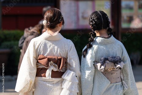 Young girl wearing Japanese kimono standing in front of Sensoji Temple in Tokyo, Japan. Kimono is a Japanese traditional garment. The word "kimono", which actually means a "thing to wear"