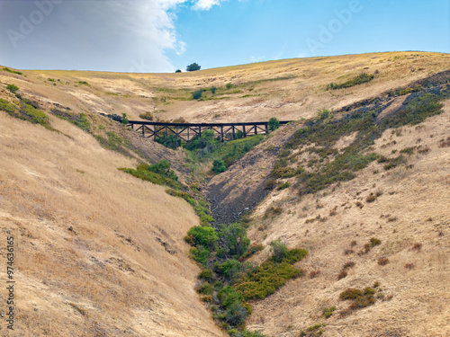 Old railroad trestle on a hill photo