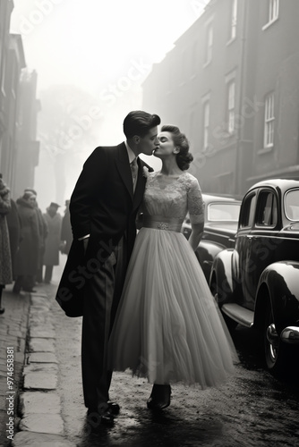 A romantic black-and-white vintage scene of a couple kissing in elegant wedding attire on a foggy street, evoking nostalgia with classic cars and bystanders watching.