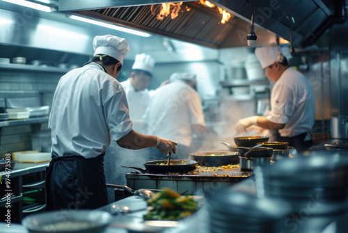  Professional chefs and kitchen staff working intensively in a busy restaurant kitchen during peak hours. 