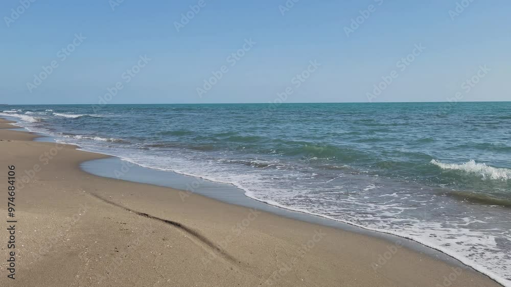 Sea waves and beach on the Mediterranean coast with sea, sand and sun for summer holidays Sea waves and beach on the Mediterranean coast with sea, sand and sun for summer holidays