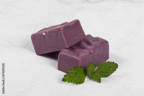 Black grape nougat. White background. Close-up