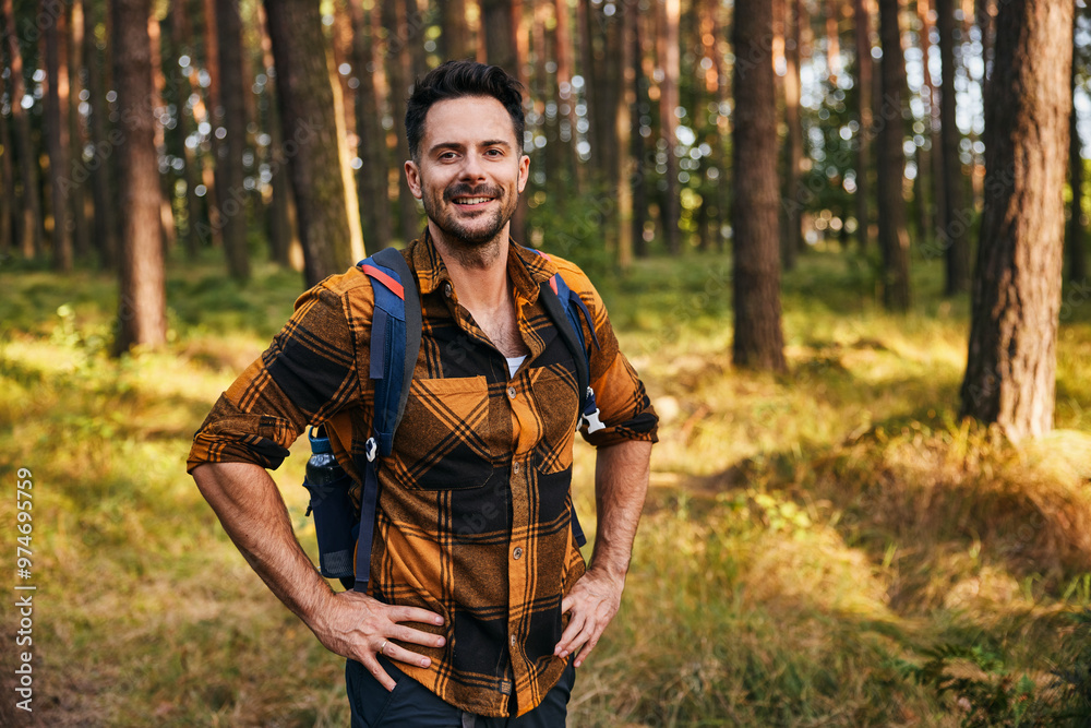 Portrait of smiling man in forest with backpack during autumn hike trip Portrait of smiling man in forest with backpack during autumn hike trip