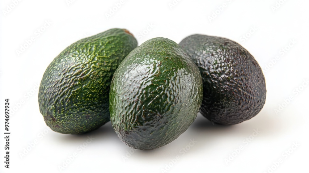Three ripe avocados arranged on a white background, showcasing their texture and color. Three ripe avocados arranged on a white background, showcasing their texture and color.