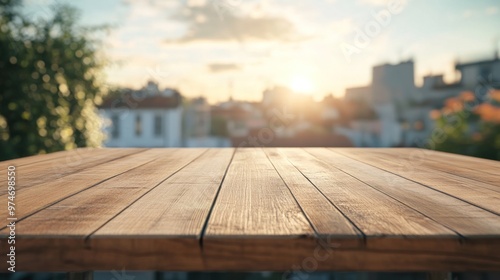 A wooden table in the foreground with a sunset view over a cityscape in the background.