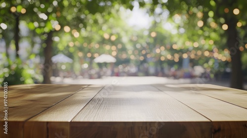 A blurred outdoor scene with a wooden table and soft lighting from surrounding trees.